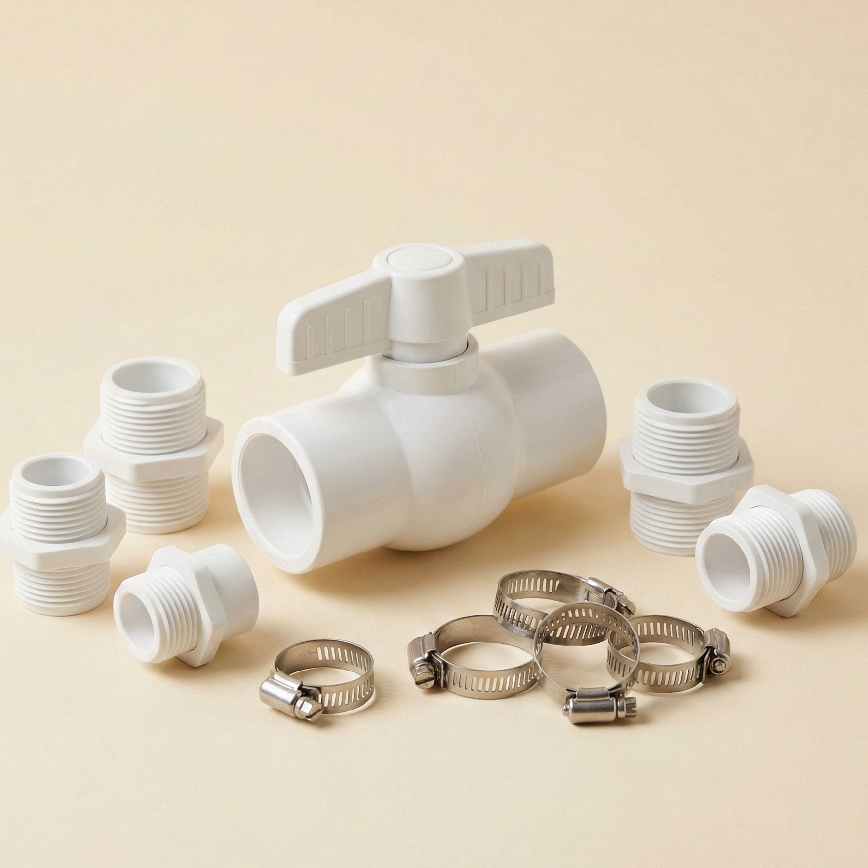 A neat arrangement of hydroponic plumbing hardware, including a PVC ball valve and bulkhead fittings.